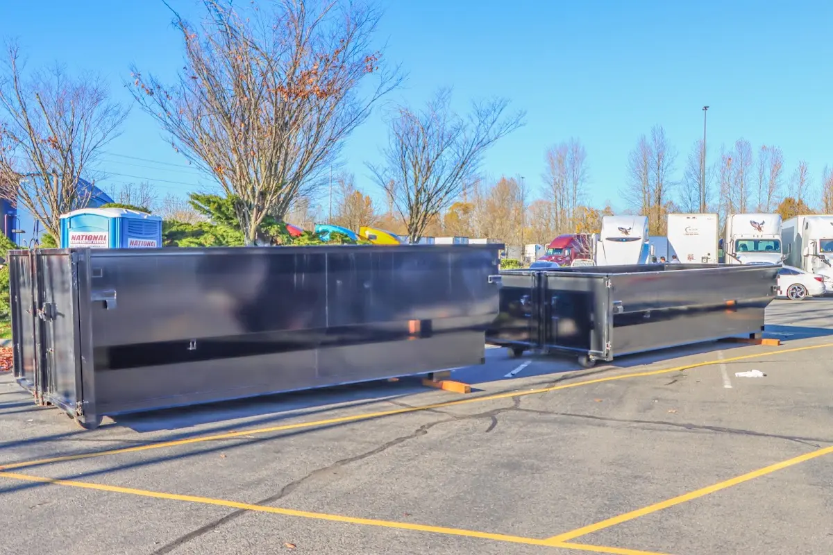 Professional dumpster rental service with roll-off container on residential driveway in Lake Station